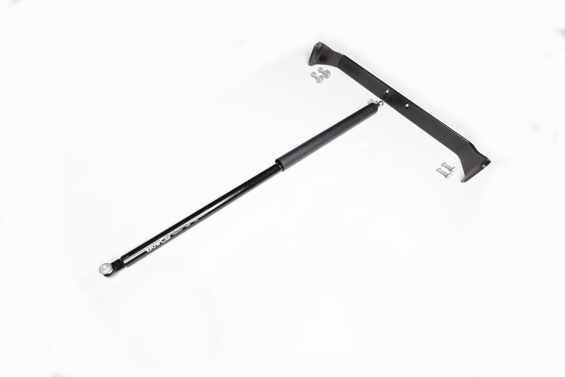 Amortiguador de gas para TowBox V3 con asa y TowBox EVO, diseñado para facilitar el abatimiento del portaequipajes de forma suave y segura.